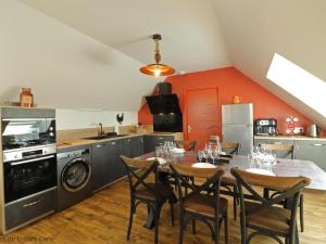 a kitchen with a table and chairs in a room at Maison confort avec Spa privatif et jardin proche de l'étang - FR-1-497-188 in Athis