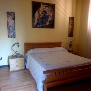 a bedroom with a bed and a lamp on a night stand at La Casita in Reggio di Calabria