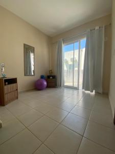 an empty living room with a large sliding glass door at Paraiso de Maracajau 4 in Maracajaú