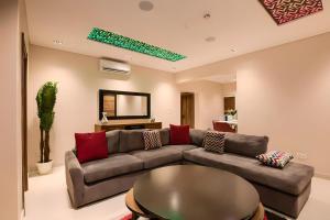 a living room with a couch and a table at Exquisitely-detailed Home in Yaba, Lagos in Lagos