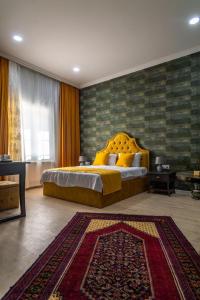 a bedroom with a king sized bed and a rug at NAR BOUTIQUE HOTEL in Baku
