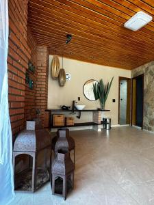 a room with a sink and a brick wall at Pousada Quinta do Barao in Conceição da Ibitipoca