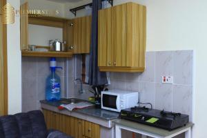 a kitchen with a counter with a microwave and a sink at Premier Stays Ruiru in Ruiru