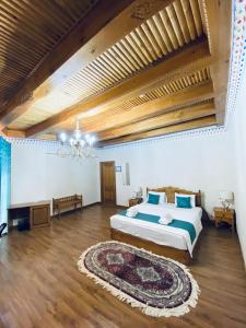 a large bedroom with a bed and a rug at Nostalgia Boutique Hotel in Bukhara