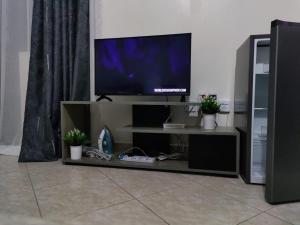 a flat screen tv sitting on a entertainment center at Premier Stays Ruiru in Ruiru
