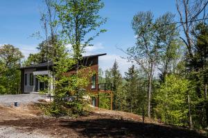 a house in the middle of the forest at Chalet Alpine by Tremblant Platinum in La Conception