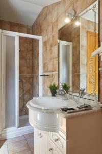 a bathroom with a white sink and a shower at Leizarooms in Leitza