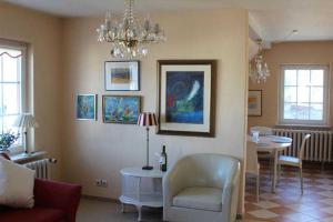 a living room with a table and a chandelier at Ferienwohnung Rundumblick in Sassnitz