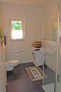 a bathroom with a toilet and a glass shower at Ferienhaus Frieda in Sagard
