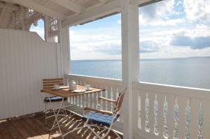 ザスニッツにあるFürstenhof - Ferienwohnung 403の海の景色を望むポーチ(テーブル、椅子付)