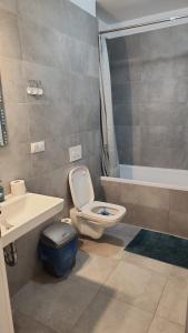 a bathroom with a toilet and a sink and a tub at Coresi KASPERS Camil Petrescu, 2 camere apartment, sleeps 6 in Braşov