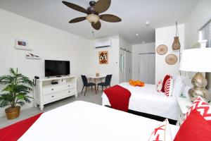 a bedroom with two beds and a flat screen tv at The No Problem at Cottages in Sand Bluff