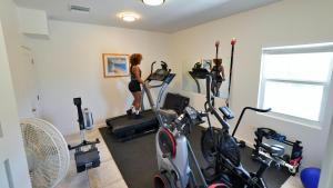 a room with two women working out on exercise bikes at The Turtle Nest at Cottages in Sand Bluff