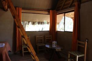 a room with a table and chairs and a window at La Montaña Parque Natural 