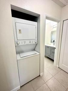 a white refrigerator in a kitchen with a sink at Snug Harbour View Condo #5 in George Town
