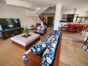 a living room with two couches and a table at Pearl Court 1111 at Pristine Bay in French Harbour