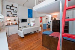a living room with a loft bed and a living room at Midtown East Next to Times Square in New York