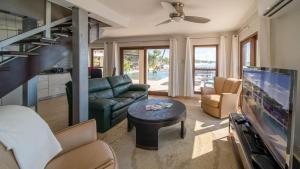 a living room with a couch and a tv at Seven Mile View Condo #1 in West Bay