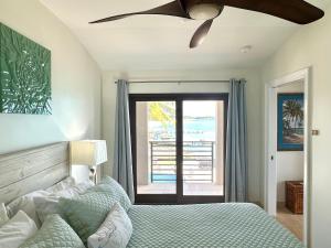 a bedroom with a bed and a ceiling fan at Seven Mile View Condo #1 in West Bay