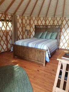 a bedroom with a bed in a yurt at Cherokee @ Sky Ridge Yurts in Bryson City