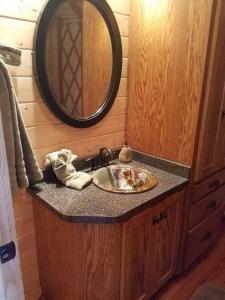 a bathroom with a sink and a mirror at Cherokee @ Sky Ridge Yurts in Bryson City