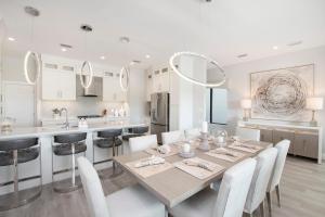 a kitchen and dining room with a table and chairs at Mahogany Villa 2-A / 4BR 