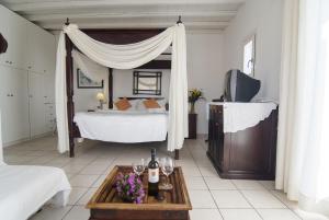 a bedroom with a bed and a table with wine bottles at Zephyros in Paraga