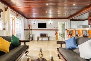 a living room with a couch and a tv at Water Lovers Paradise! in Ocho Rios