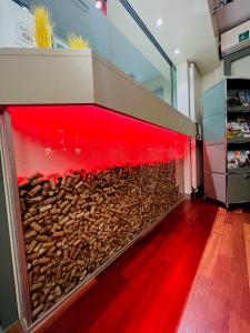 a large fish tank in a room with red lights at Vinum at Felmis SELF CHECK-IN in Luzern