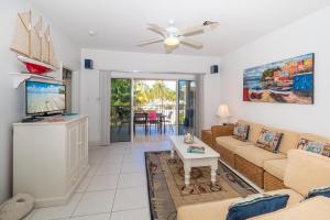 a living room with a couch and a tv at Kaibo Sunset Condo in Driftwood Village