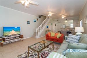 a living room with a couch and a tv at Northern Lights #4 Condo in Old Man Bay