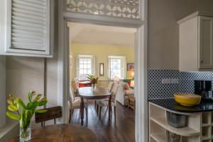 a kitchen and living room with a table and a dining room at Melrose Apartment in Roseau