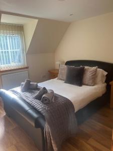 a bedroom with a large bed with towels on it at Druid Apartment in Inverness
