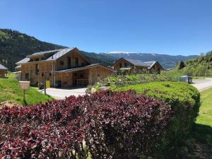a hedge of red flowers in front of a building at Chalet-Prinz-Murau-Kreischberg in Murau