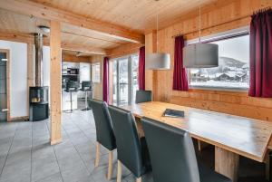 a dining room with a wooden table and chairs at Chalet-Prinz-Murau-Kreischberg in Murau