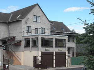 a brick house with a black roof at Arsenal in Daugavpils