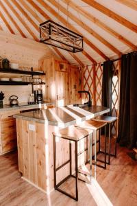 a kitchen with a large island in a wooden house at Santeetlah @ Sky Ridge Yurts in Bryson City