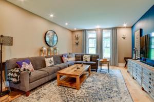 a living room with a couch and a tv at Secluded Home with Hot Tub about 5 Mi to Cornell! in Ithaca