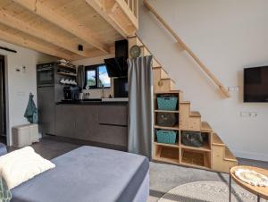 a tiny house with a staircase and a kitchen at Klavertje 4 in Middelaar