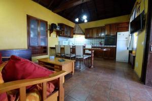 a kitchen with a couch and a table and a refrigerator at Casa Pancha in Garafía
