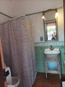 a bathroom with a shower curtain and a sink at Casa Pancha in Garafía