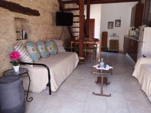 a living room with a couch and a table at Symela's Nest in Anoyira