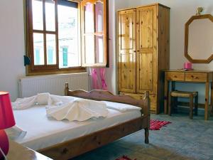 Postel nebo postele na pokoji v ubytování Guesthouse Rousis