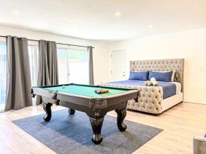 a bedroom with a pool table in front of a bed at Gorgeous 4BR House with Swimming Pool in Topanga