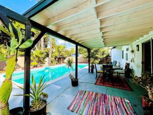 a patio with a table and a swimming pool at Gorgeous 4BR House with Swimming Pool in Topanga