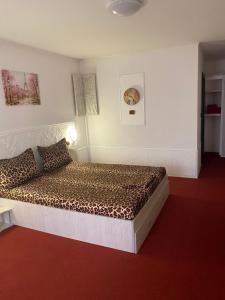 a bedroom with a bed in a white room at Karra Hotels in Voluntari