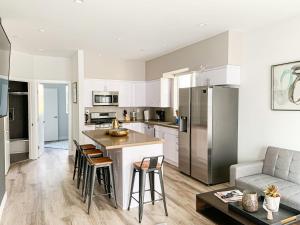 a kitchen and living room with a couch and a table at Spacious Townhouse in Mid City - CR4-WIN in Los Angeles