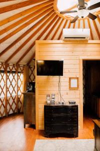 a room with a wall with a television and a ceiling at Tuckaseegee @ Sky Ridge Yurts in Bryson City