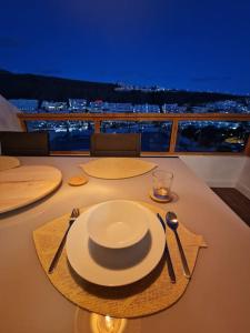 a table with a white plate and fork and knife at Arimar Sun 13 Puerto Rico in Puerto Rico de Gran Canaria