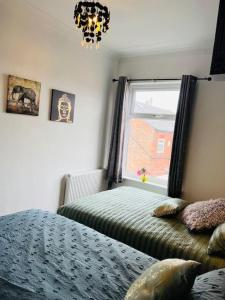 a bedroom with a bed and a window at The First-central Wigan 8 guests in Wigan